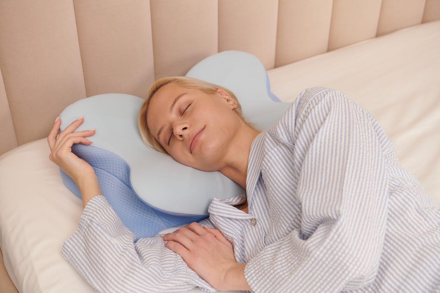 Woman sleeping comfortably on a contoured ergonomic pillow